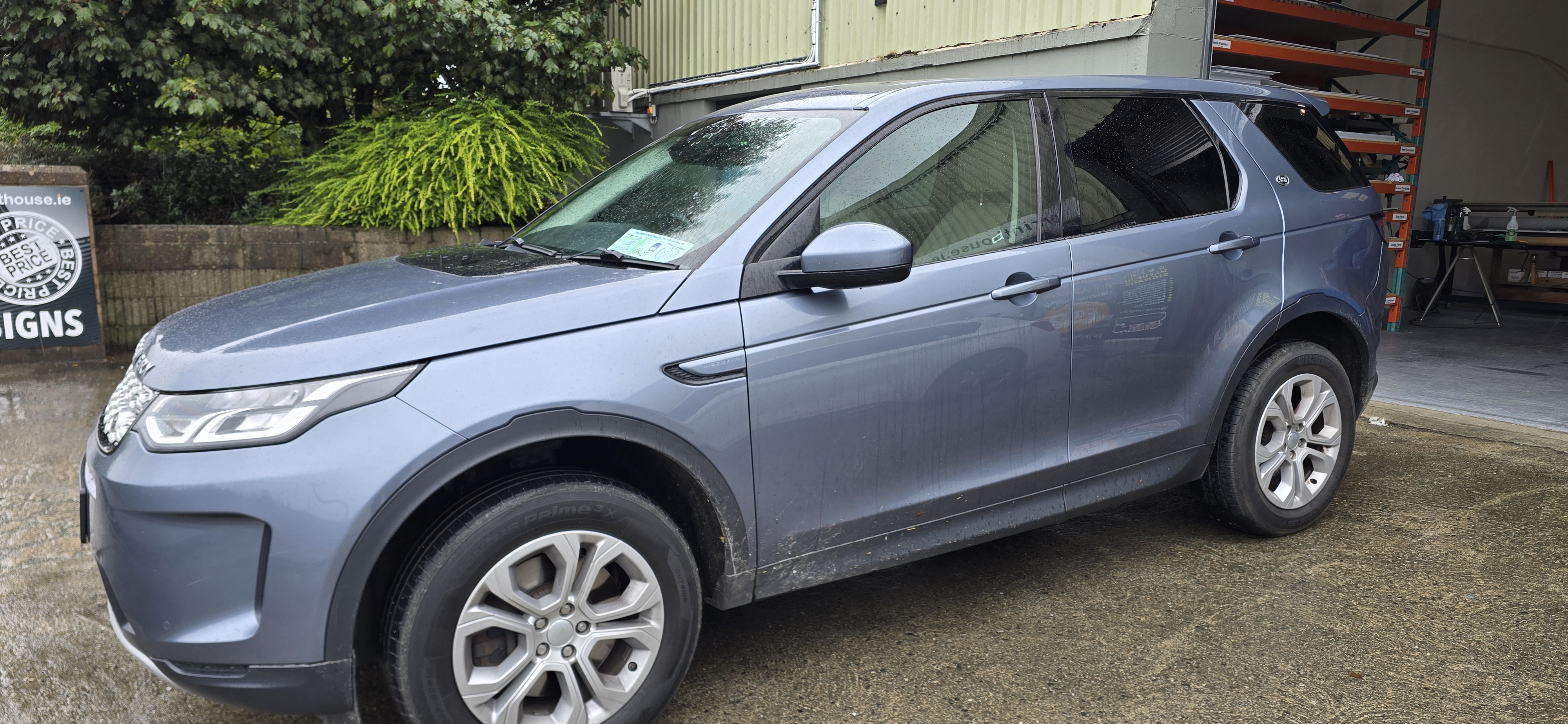 Front three-quarter view of a grey Land Rover Discovery Sport showing legal 70% tinted front windows