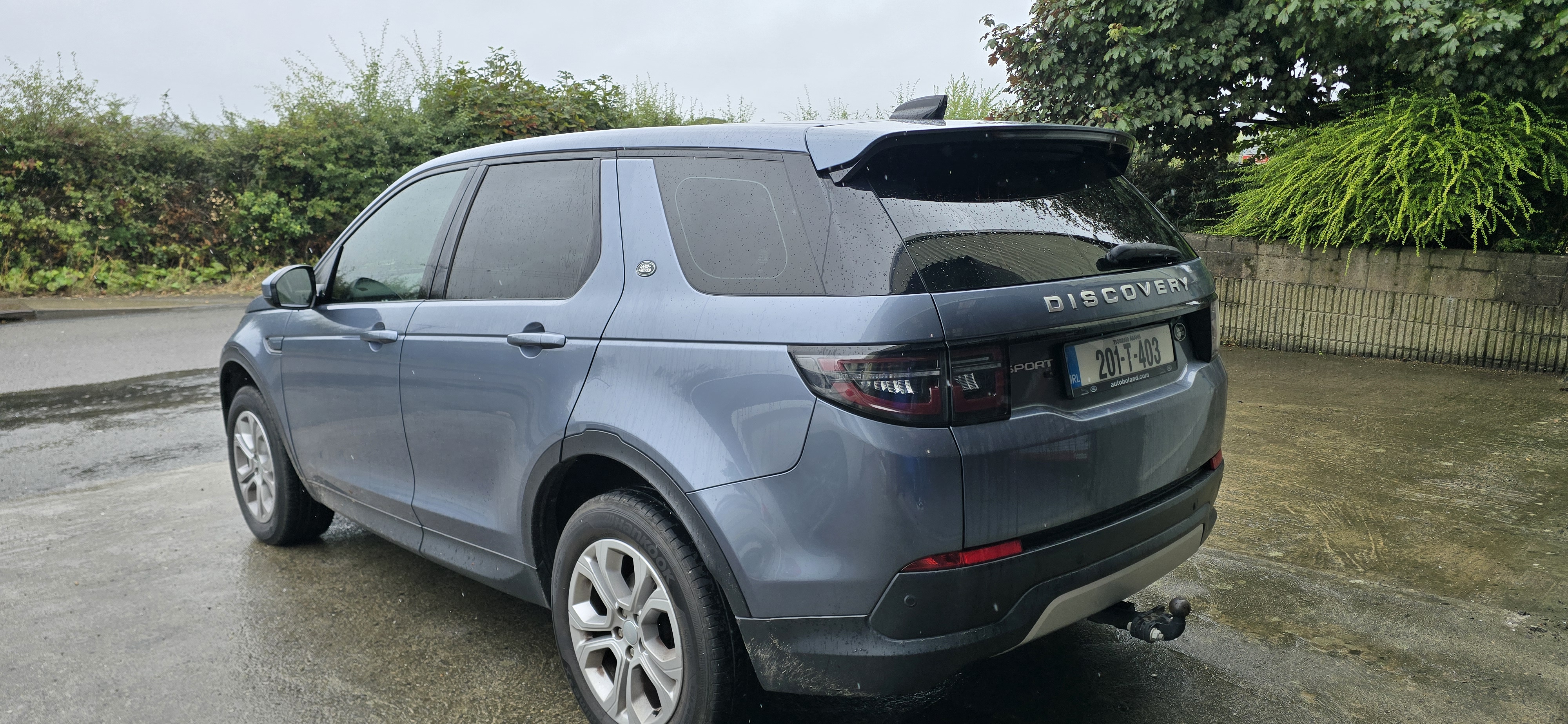 Rear three-quarter view of a grey Land Rover Discovery Sport with 20% tinted rear windows in Co. Wexford