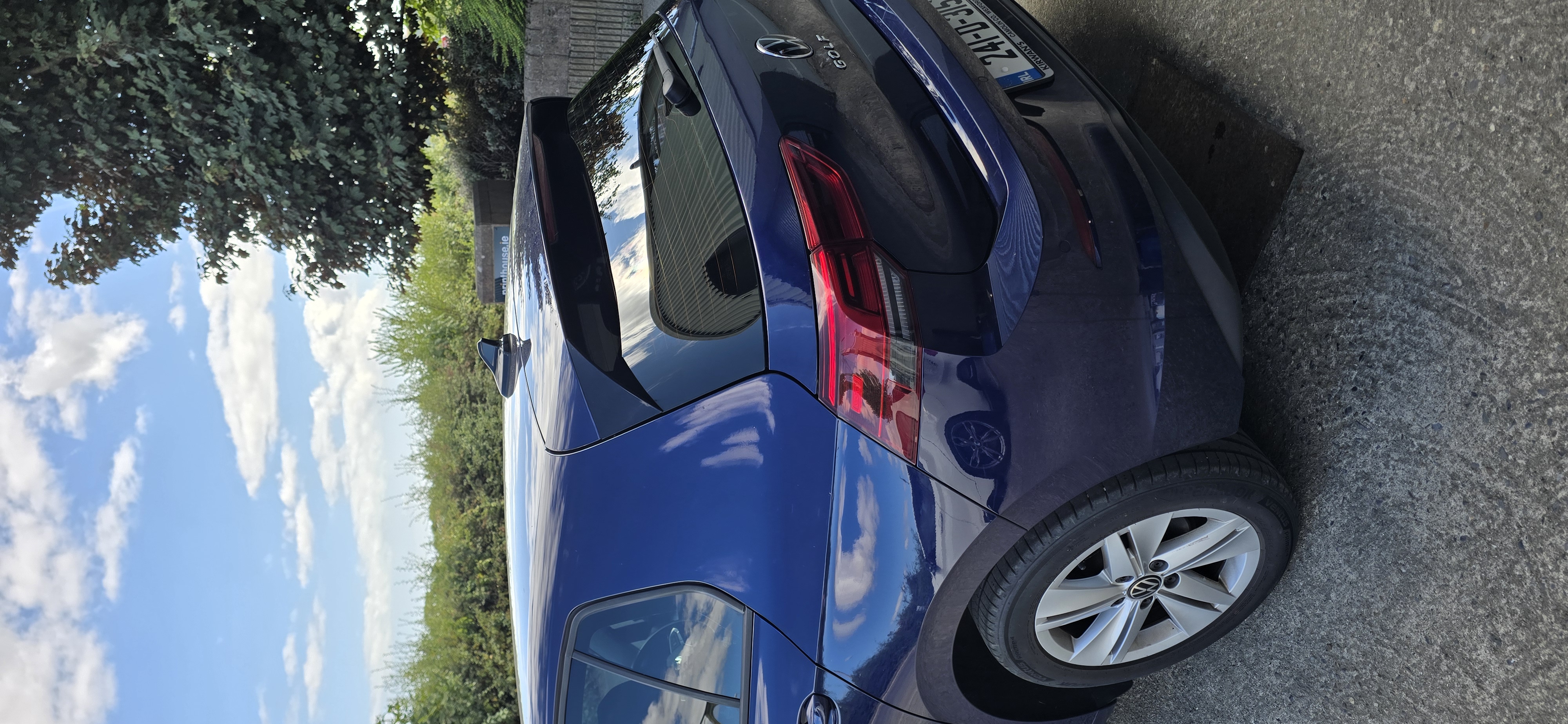 Rear quarter view of a blue Volkswagen Golf showing tinted rear screen and side glass