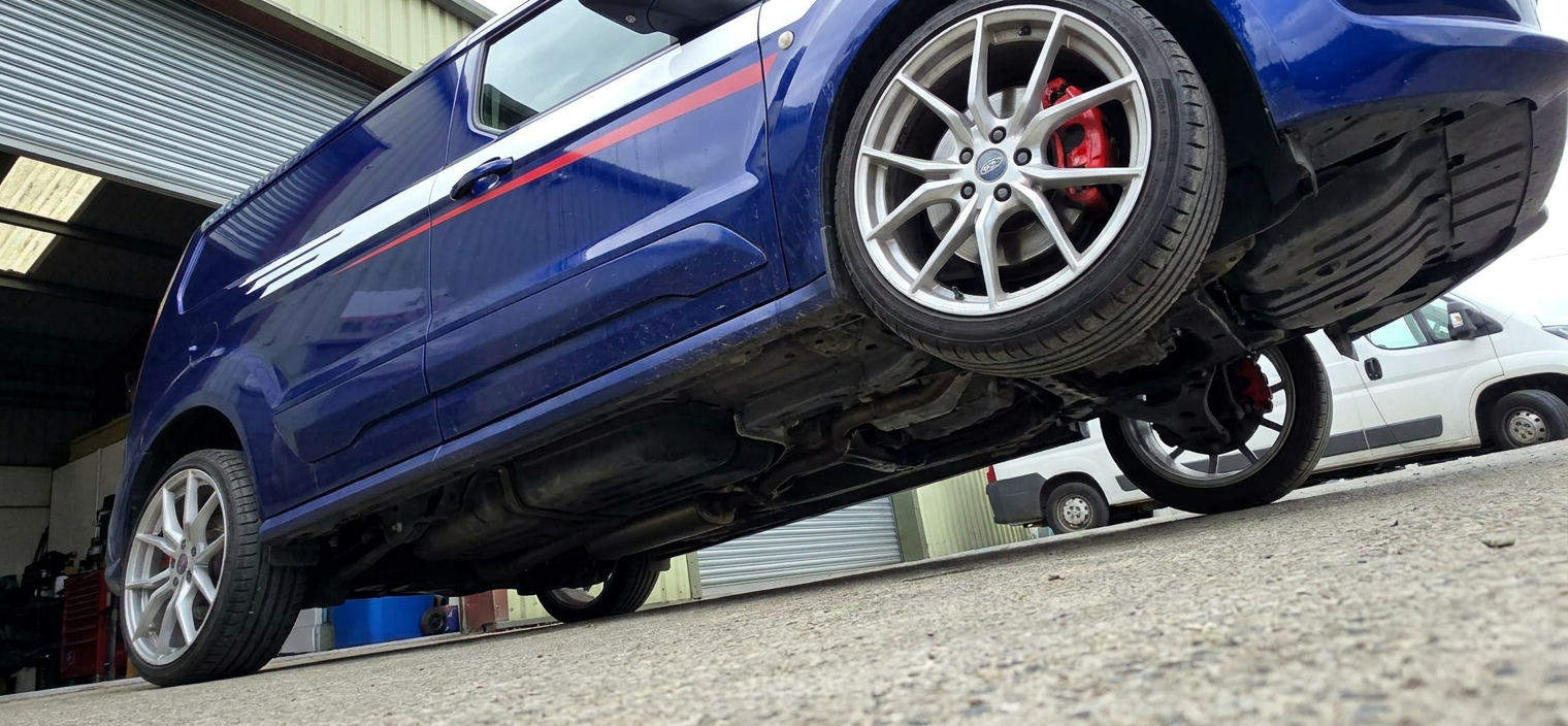 Low angle shot of a blue Transit Connect Sport on a lift with tinted side glass